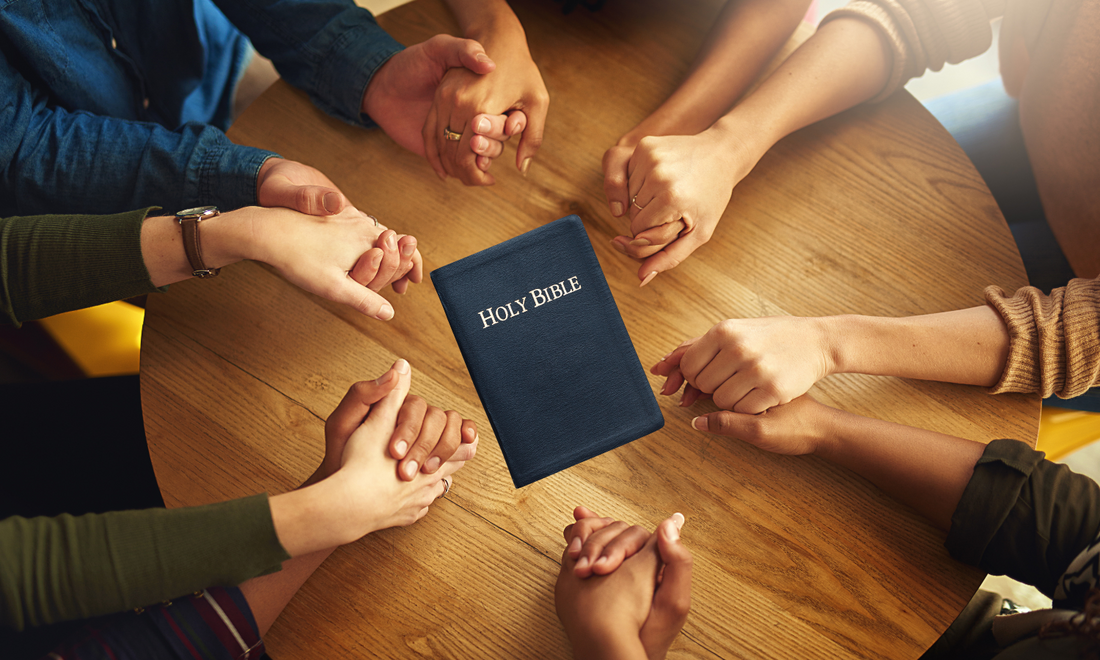 family holding hands in prayer