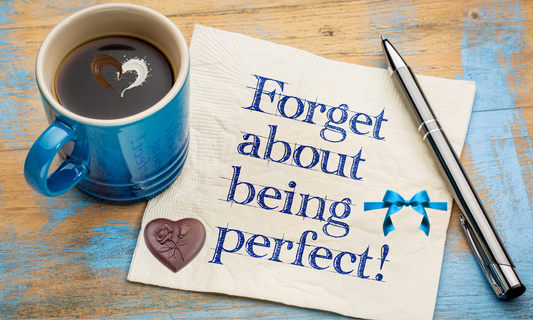 A cup of chocolate with a pen and a note