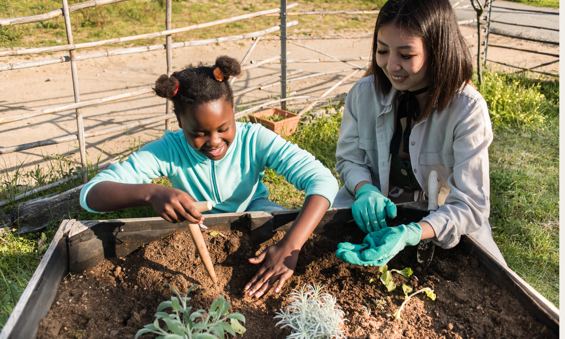 A child and an adult planting seeds