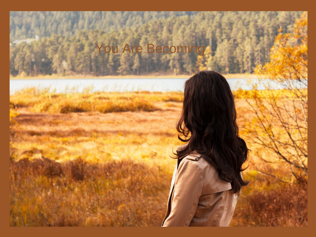 Warm, inviting image of a woman in soft light, looking toward the horizon