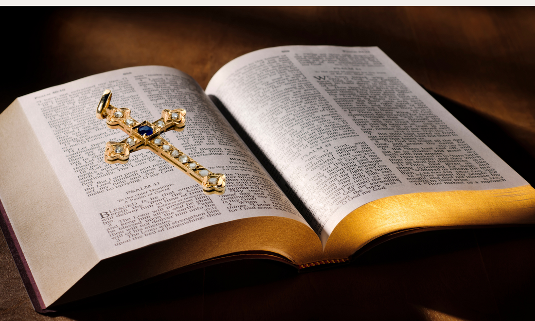 An open Bible with a cross pendant resting on it